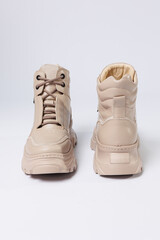 Beautiful shoes on an isolated white studio background. Fashionable beige women's shoe. Elegant stylish footwear.