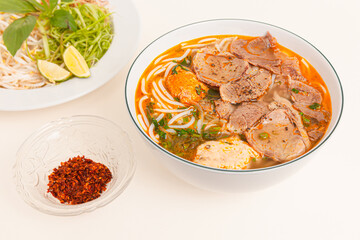 Bun Bo Hue, Vietnamese spicy beef rice noodle soup, Vietnamese food isolated on white background, closeup