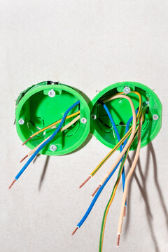 Boxes for electrical outlets with wires. Carrying out electrical wiring and installation of outlets in the house