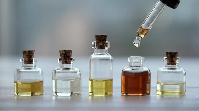 Dropping aromatherapy essential oil into a bottle, slow motion