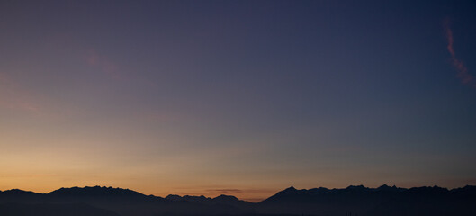 moncalieri, italy, horizon at sunset, mountains and sky in gradient shades in the background