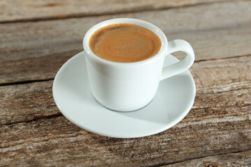 Cup of tasty coffee on wooden table
