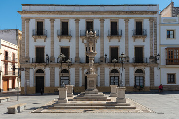 Obraz premium Historic buildings in Plaza de España in the old town of El Puerto de Santa Maria on a summer day, Cadiz, Andalusia, Spain