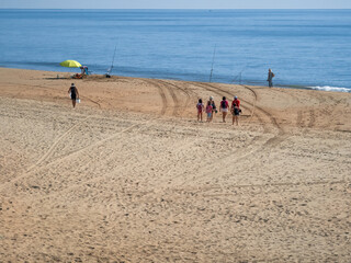 People and fishermen in autumn beach atmosphere