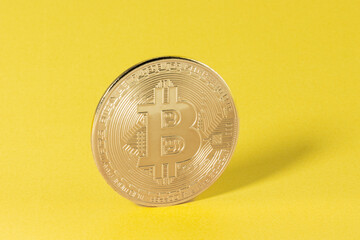 Golden Bitcoin on yellow background. Symbol of wealth and success. Concept of Exchange trading, Digital currency, Cryptocurrency, Business and Banking