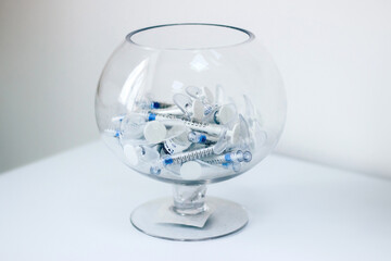 Kharkiv, Kharkiv Oblast, Ukraine - 08 18 2021: syringes in a vase glass