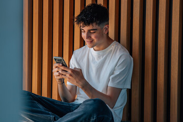 young boy with mobile phone on the street