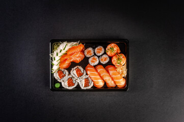 Sushi salmon varieties in delivery tray.