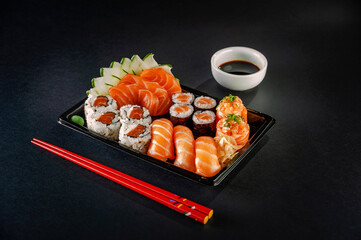 Sushi salmon varieties in delivery tray.