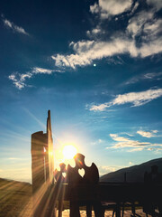 alpine motive, heart shaped wood carving in a Chair, sweet, beautiful, backlit with sun, silhouette and  blue sky
