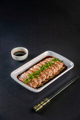 Blowtorcherd salmon sashimi with passion fruit sauce.