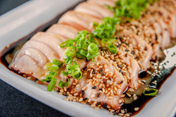 Blowtorcherd salmon sashimi with passion fruit sauce.