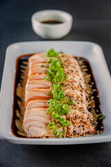 Blowtorcherd salmon sashimi with passion fruit sauce.