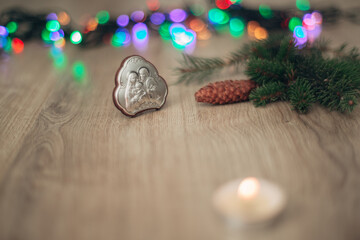 Christmas Composition of Candle on a Wooden Background With colorful Light