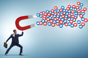 Businessman attracting likes with large magnet