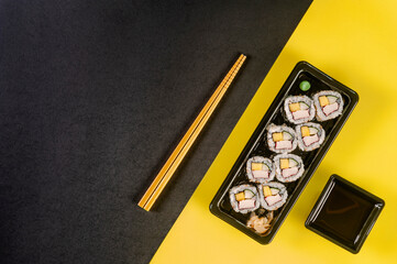 Uramaki with cucumber, mango fruit and crab sticks.