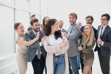 Fototapeta premium smiling business lady and happy business team standing together