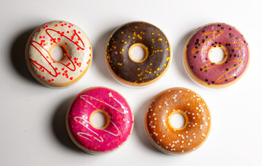Various coloured doughnuts on a white background