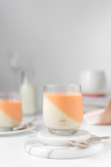 Vanilla and orange creamsicle panna cotta, panna cotta served in a glass cup, cooked cream in a glass cup, coral panna cotta dessert