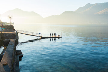 italian fishermen fishing at sunset in como lalke