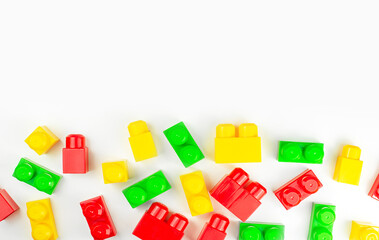 red, yellow and green building blocks on white background with copy space