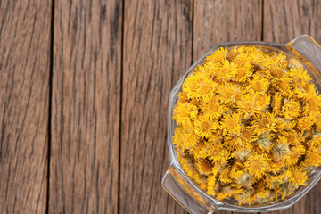 Chrysanthemum flowers isolated on an old wood background. top view.