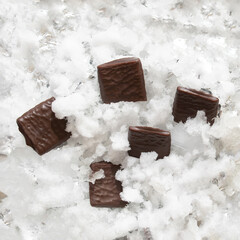 chocolates in snow.silver metallic white aesthetic valentine design.love gifts concept.food flat lay