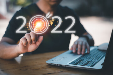 usiness planning and strategy in 2022, life planning in 2022, progress or success concept, businessman's hand Show letters 2022