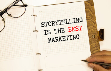 Storytelling is the best Marketing - written on a notebook with a pen.