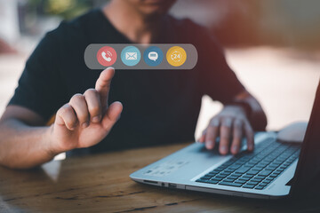 Contact us or the connected customer support hotline. Businessman using laptop and tapping contact...
