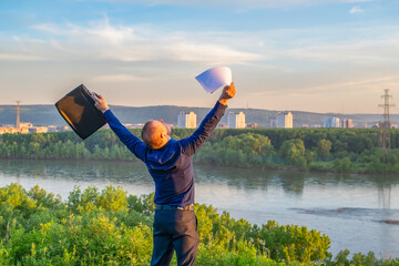 a happy person, an office worker, raising his hands up rejoices at a bargain