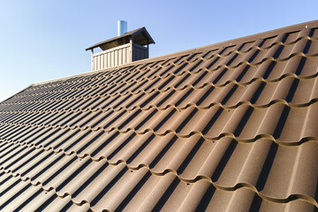 Closeup of house roof top covered with metallic shingles