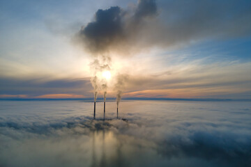 Coal power plant high pipes with black smoke moving upwards polluting atmosphere. Production of...