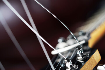 Strings on a black background. Metallic thread. Chord, cord, train, stream, range, track. Electric guitar closeup detail.                              