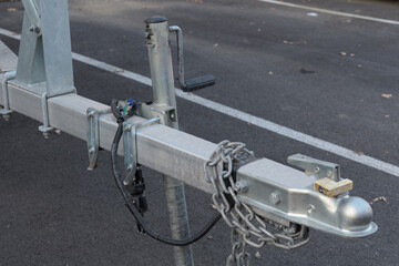 Car tow hitch with trailer lock handle and electrical socket close up side view, safety driving...