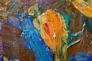 Abstract image painted with large sweeping strokes of oil paint on the surface of canvas, close up. Creative work of the artist. Colorful and bright background. Work of impressionist.