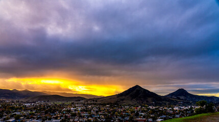 Sunrise, Sunset over the silhouetted Mountain Peaks, city, town