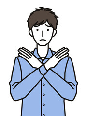 手でばつのジェスチャーをする男性