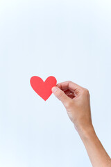 Obraz na płótnie Canvas Vertical photo of a hand holding a heart