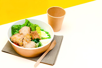 Healthy food lunch in kraft paper carton eco friendly box disposable bowl packaging container, cup on yellow background. chicken, eggs, greens. Take away delivery. environment protection copy space