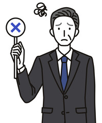 ばつのふだを持つシニア男性