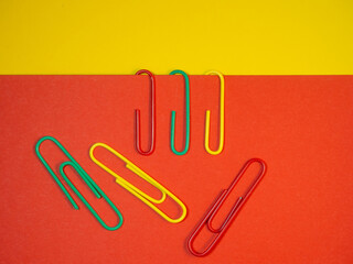 Large multi-colored paper clips. Paperclip of documents. Desktop.