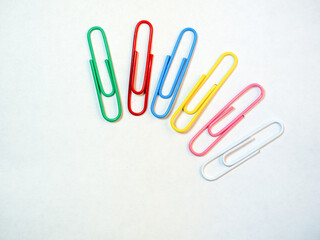 Large multi-colored paper clips. Paperclip of documents. Desktop.
