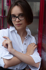A young woman with short brown hair, wearing a white shirt