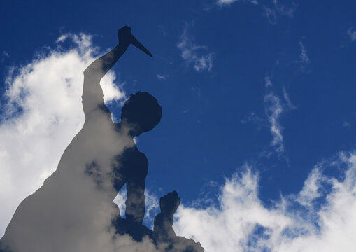 Silhouette of fake heavy fight under blue and white sky