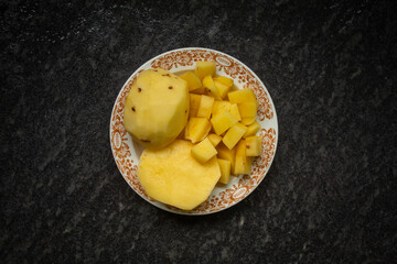 Fresh peeled potatoes on a plate for advertising and background purposes