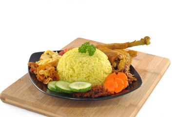 Yellow turmeric rice is is a typical Indonesian food, on wooden table