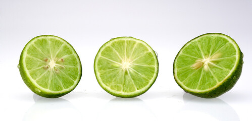three fresh lime slices isolated on white background