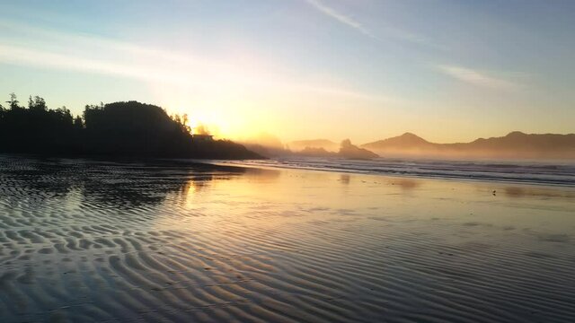 Sunrise At The Beach Reflecting In The Sand 