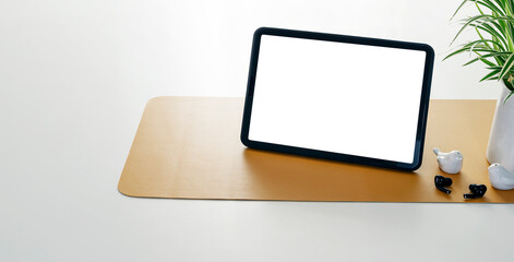 Blank white screen digital tablet and gadget on white table with copy space.